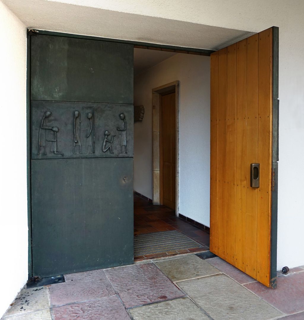 Works of Mercy Church portal with open door leaf
