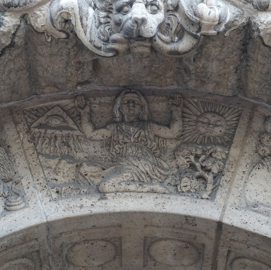 facade decoration at Melanchthon-Gymnasium "Religion", A kneeling female figure, on the left the eye of God, on the right the sun.