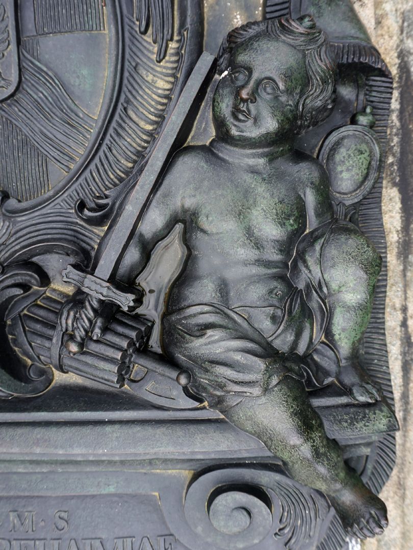 Gravesite of Carl Friedrich Behaim Putto with axe in rod bundle (fascis), sword and mirror