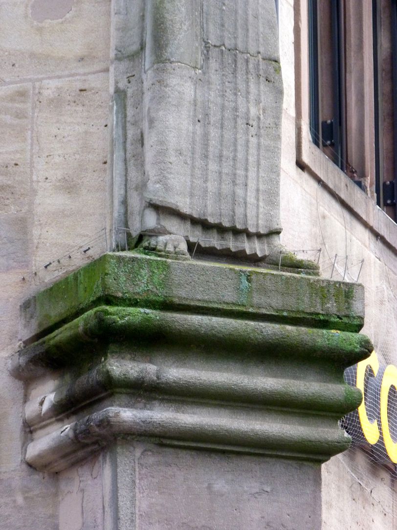 Figure with cornucopia Capital and transom on the buttress